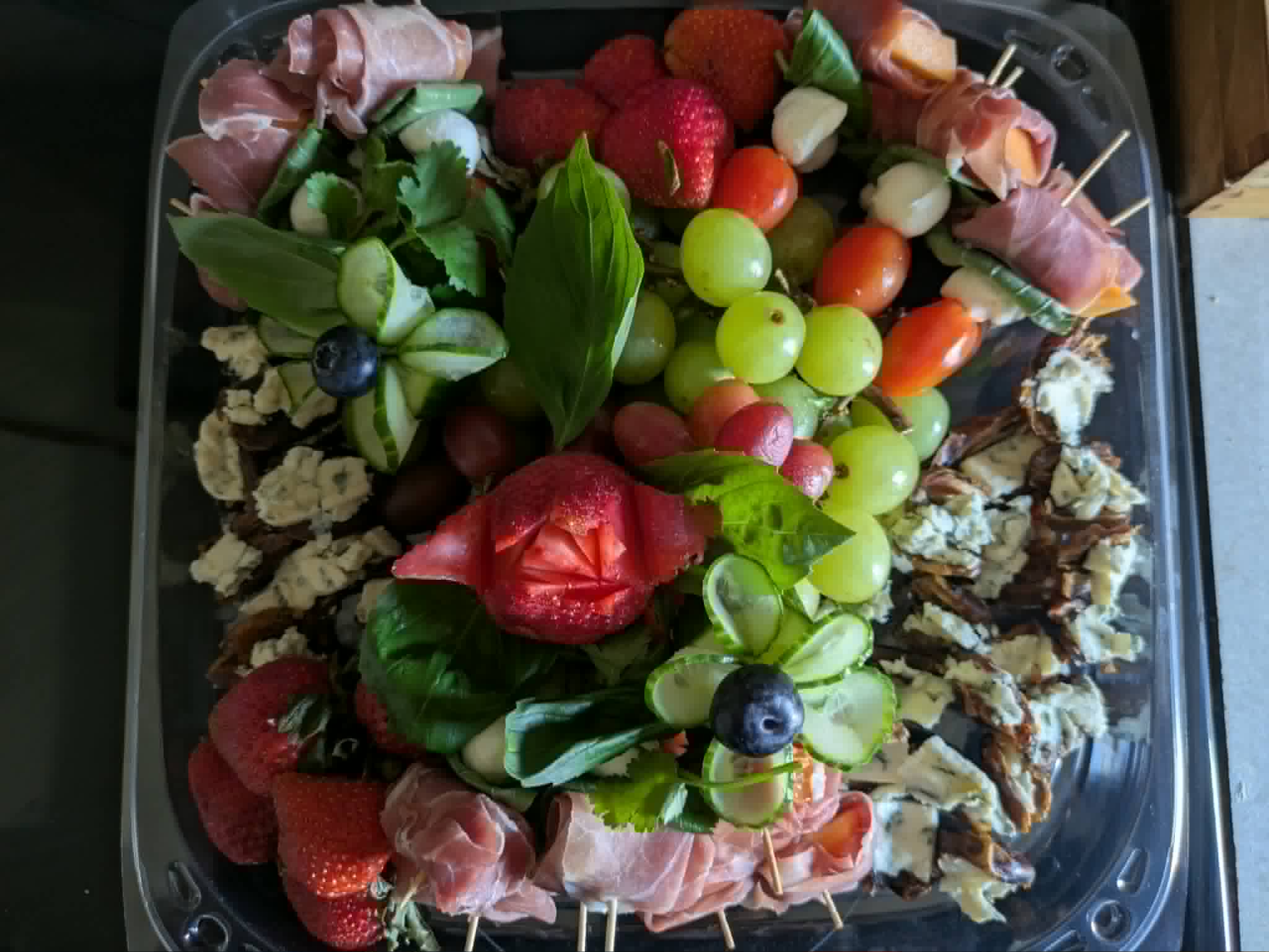 A collection of tasty fruit and cheeeses.